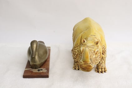 a brass duck, and a Molded model of rhino