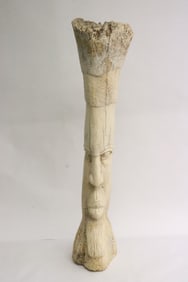 A massive bone carving in the motif of human face