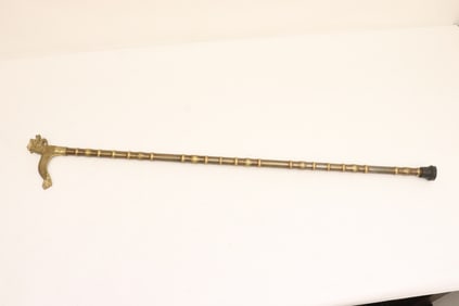 A bronze/ brass cane