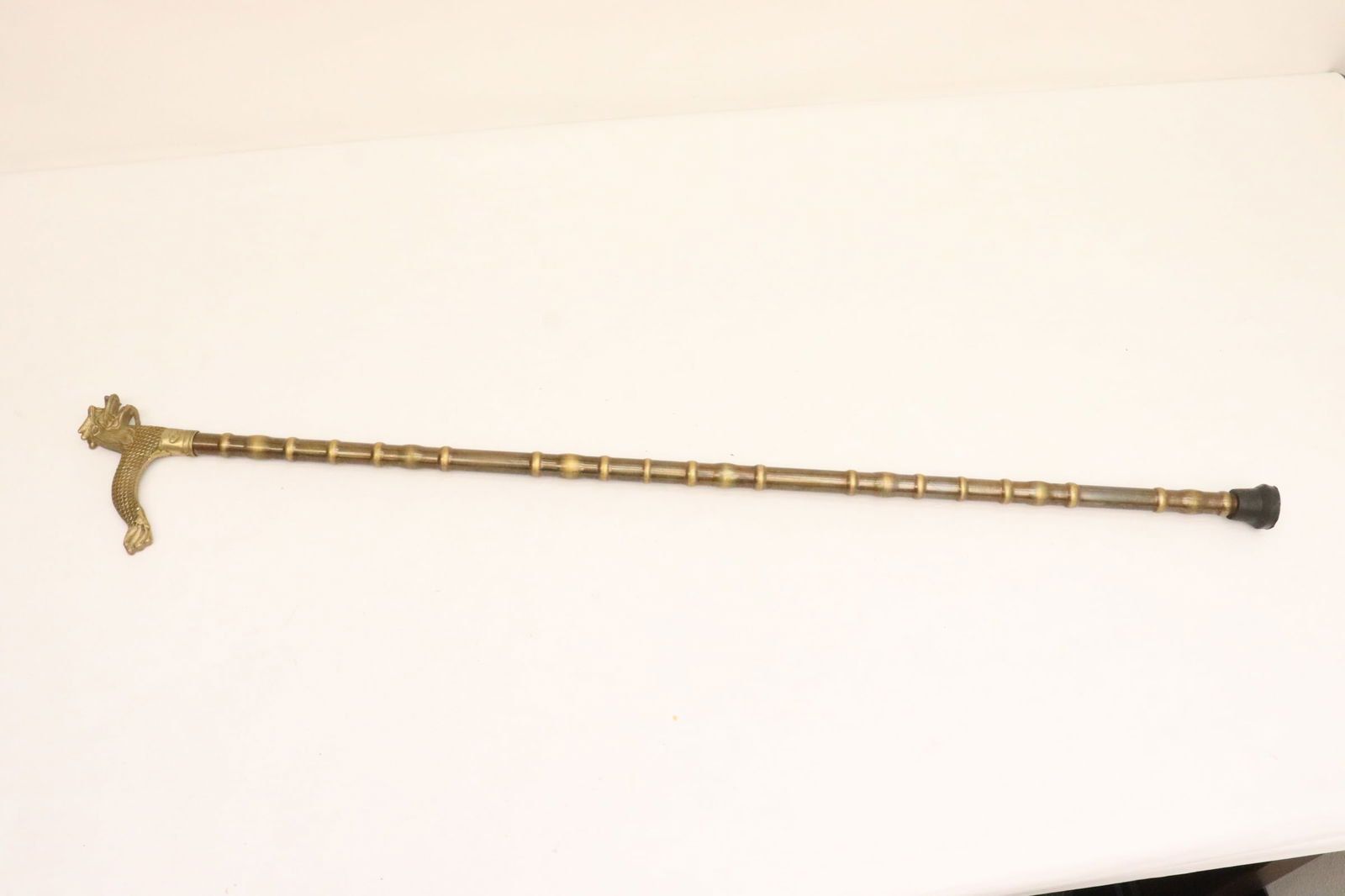 A bronze/ brass cane: A bronze/ brass cane, 35.65"L