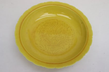 A yellow glazed porcelain plate