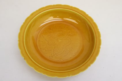 A yellow glazed porcelain plate