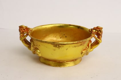 A gilt metal cup