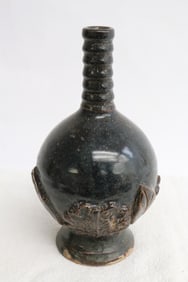 A brown glazed earthenware jar