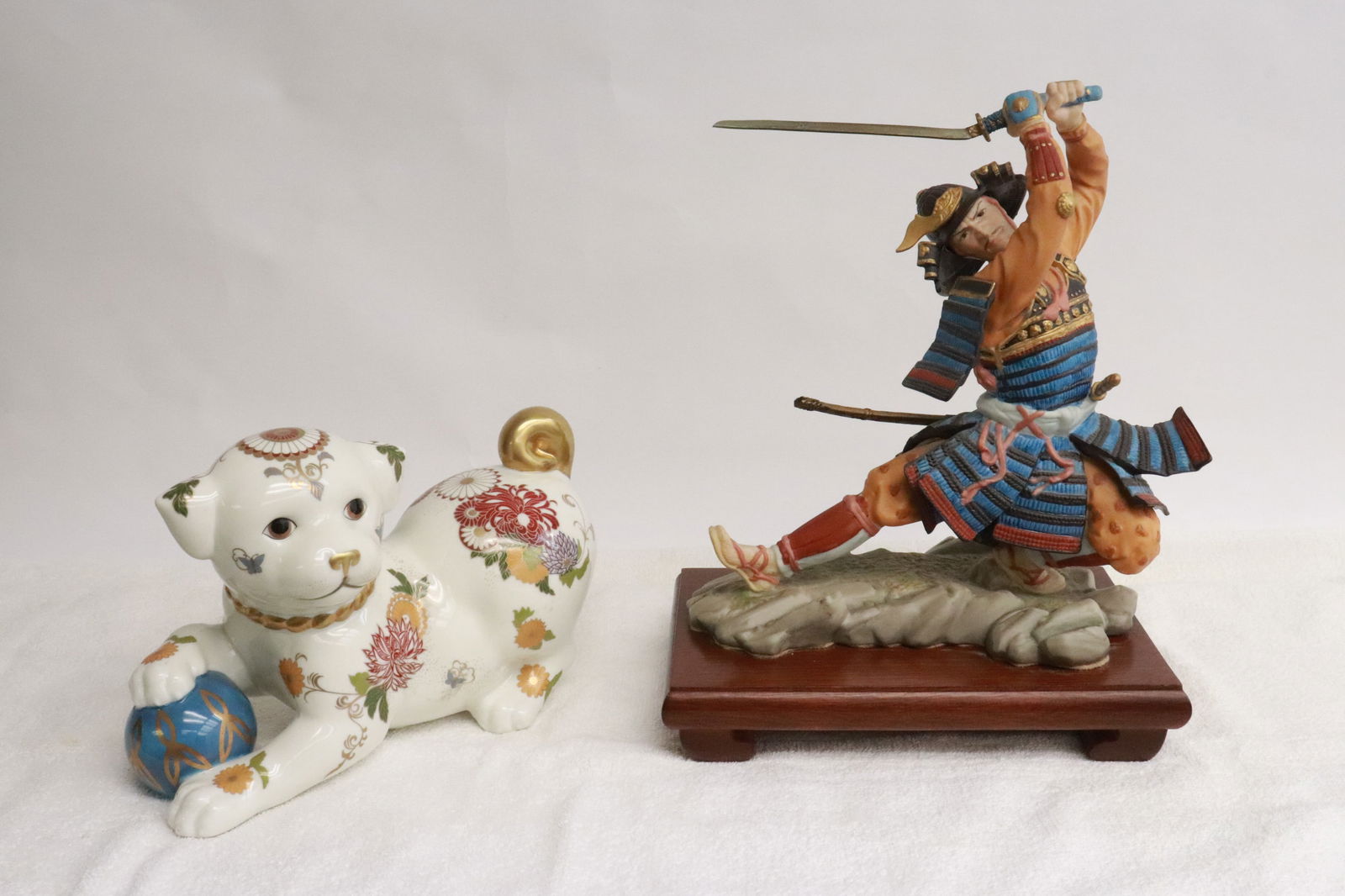 a satsuma porcelain dog, and a bisque sculpture: 2 pieces; a satsuma porcelain dog (5.9"H), and a bisque sculpture of samurai warrior (9.35"H)