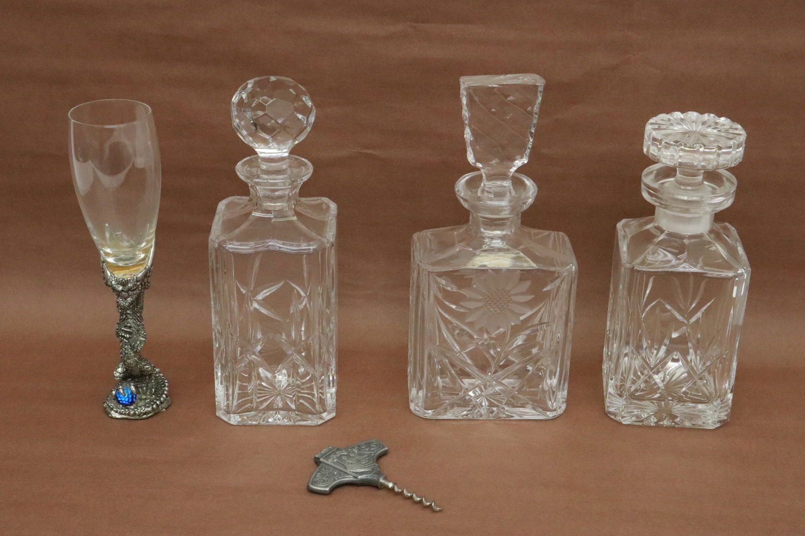 5 pieces: 5 pieces; 3 crystal decanters (8.9"x3.65"x3.65" - 10.3"x4.75"x2.8"), a wine cup with fancy pewter base (9.4"x2.45"dia), and a wine bottle opener (4.3"x3"x0.35")