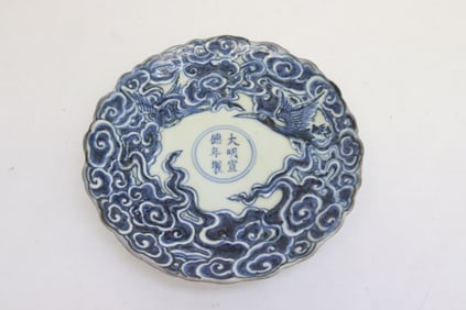 Blue and white porcelain plate with fluted edge