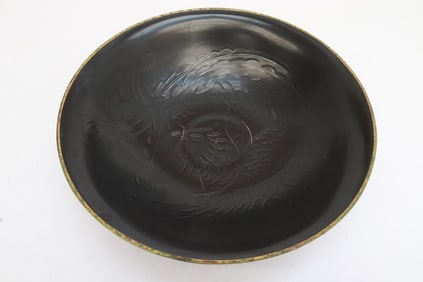 A large brown glazed porcelain bowl