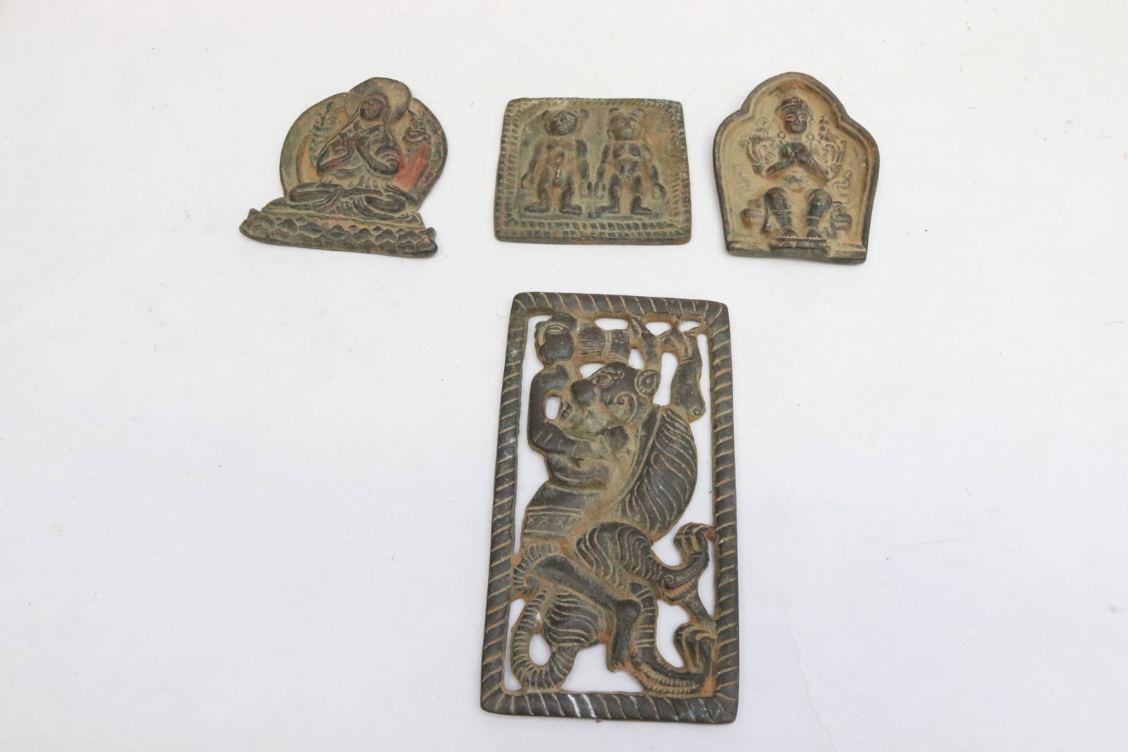 4 Chinese bronze small plaques: 4 Chinese bronze small plaques with deity motif decoration in relief, 2.35"x2.5"x0.4" - 4.85"x2.7"x0.35"