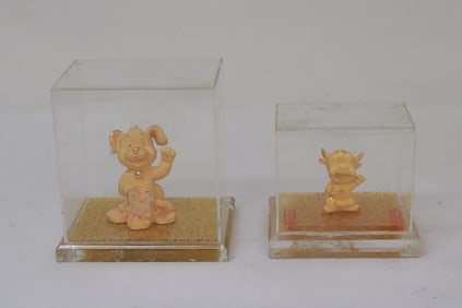 2 gold plated animal motif ornaments in boxes