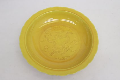 A yellow glazed porcelain plate