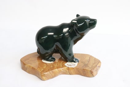 Dark green jade carved bear on stone stand