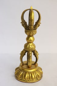 A gilt bronze Tibetan relic on stand
