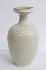 A white porcelain vase with embossed decoration