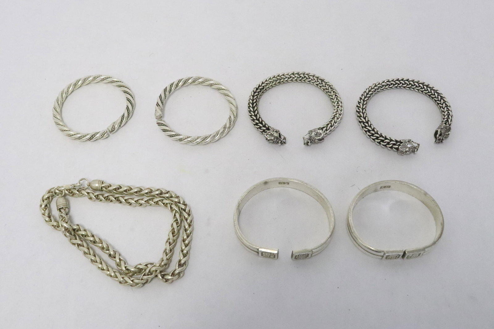 6 white metal bangles, & a white metal necklace: 6 white metal bangles (0.25"x2.75"dia - 0.5"x3.2"dia), and a white metal necklace (24.2"L)