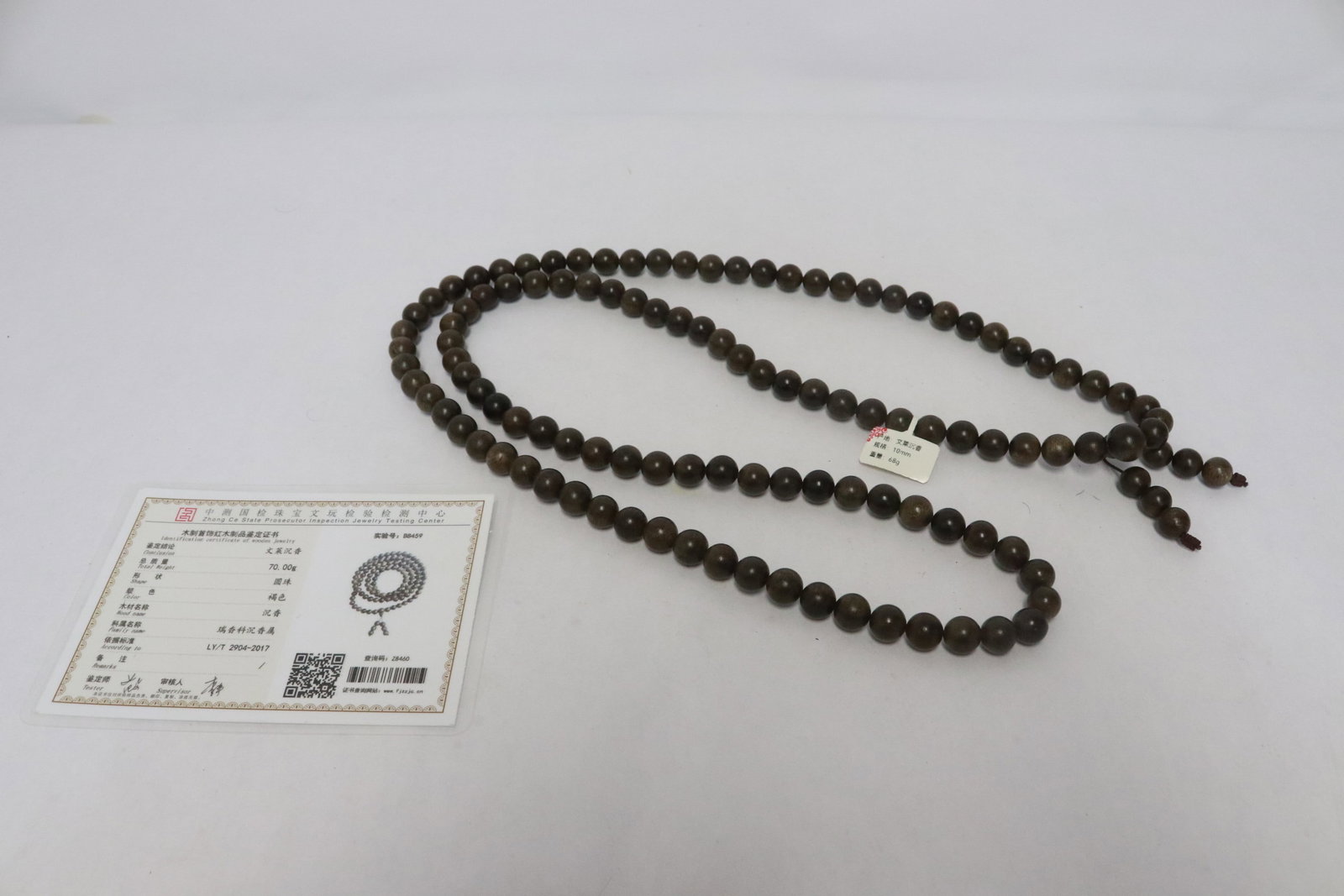 A chenxiang wood necklace: A chenxiang wood necklace (47"L) (beads:0.4"x0.4"dia ea, box:1.7"x4.7"x4.7")