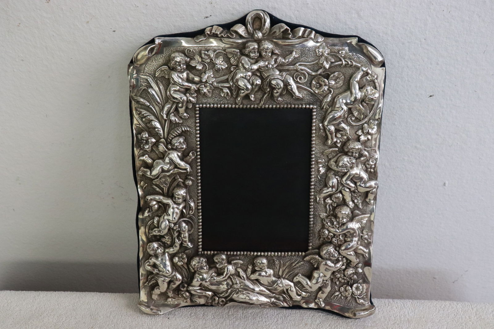 Magnificent sterling silver picture frame: Magnificent sterling silver picture frame decorated with angels in high relief, 11.6"x9.2"x1.6"