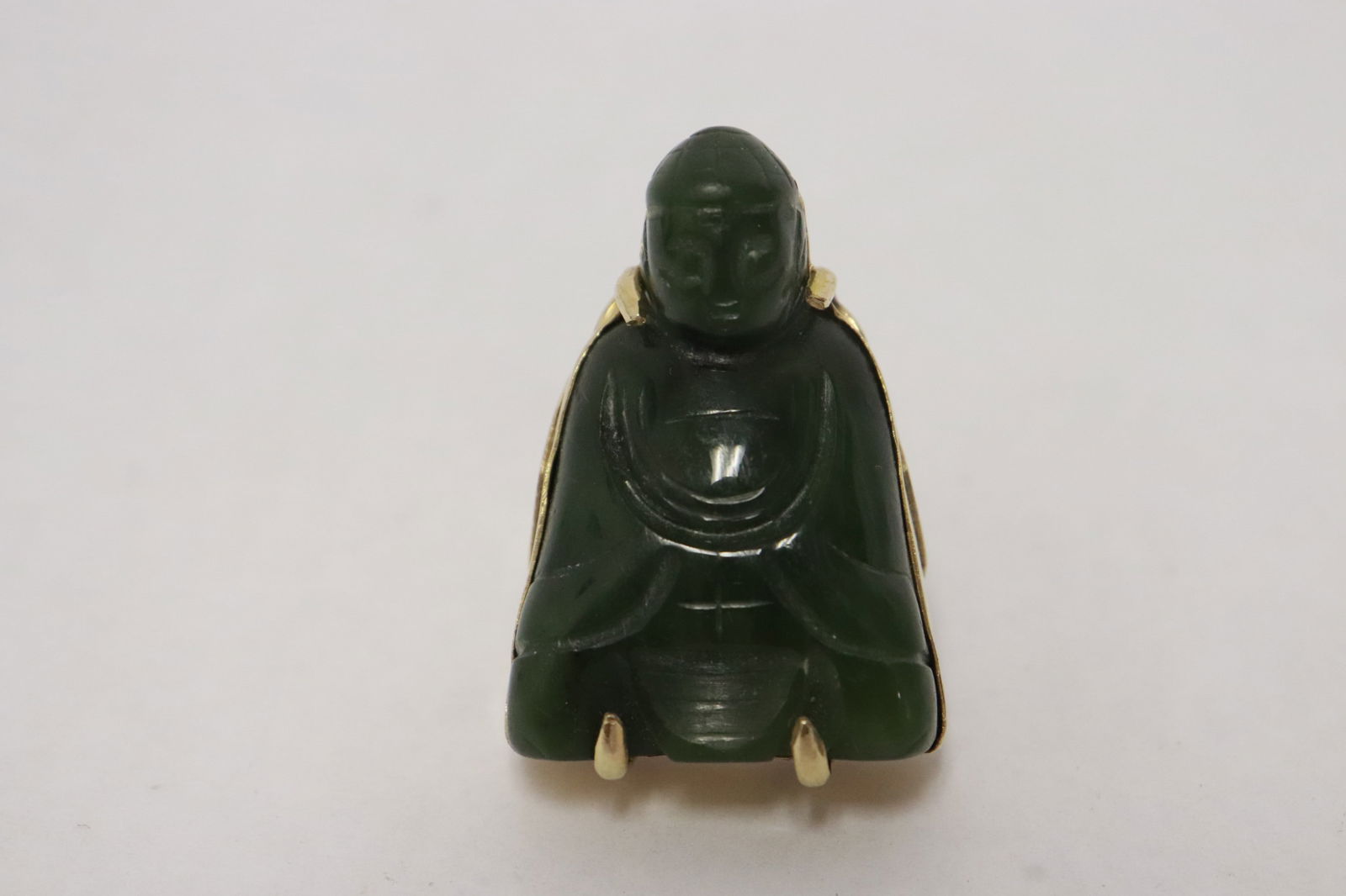 A heavy 14K Y/G ring w/ jade carved Buddha: A heavy 14K Y/G ring set with a green jade carved Buddha, wt. 31.1gm, size 8.5