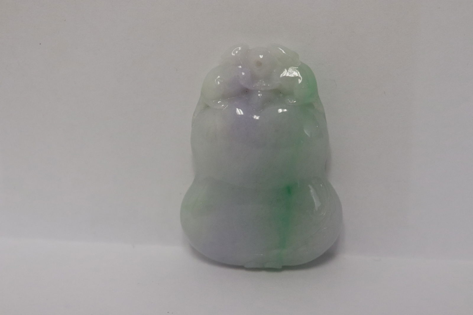 A fine light apple green jadeite pendant: A fine light apple green jadeite pendant, 1.75"x1.18"x0.35"