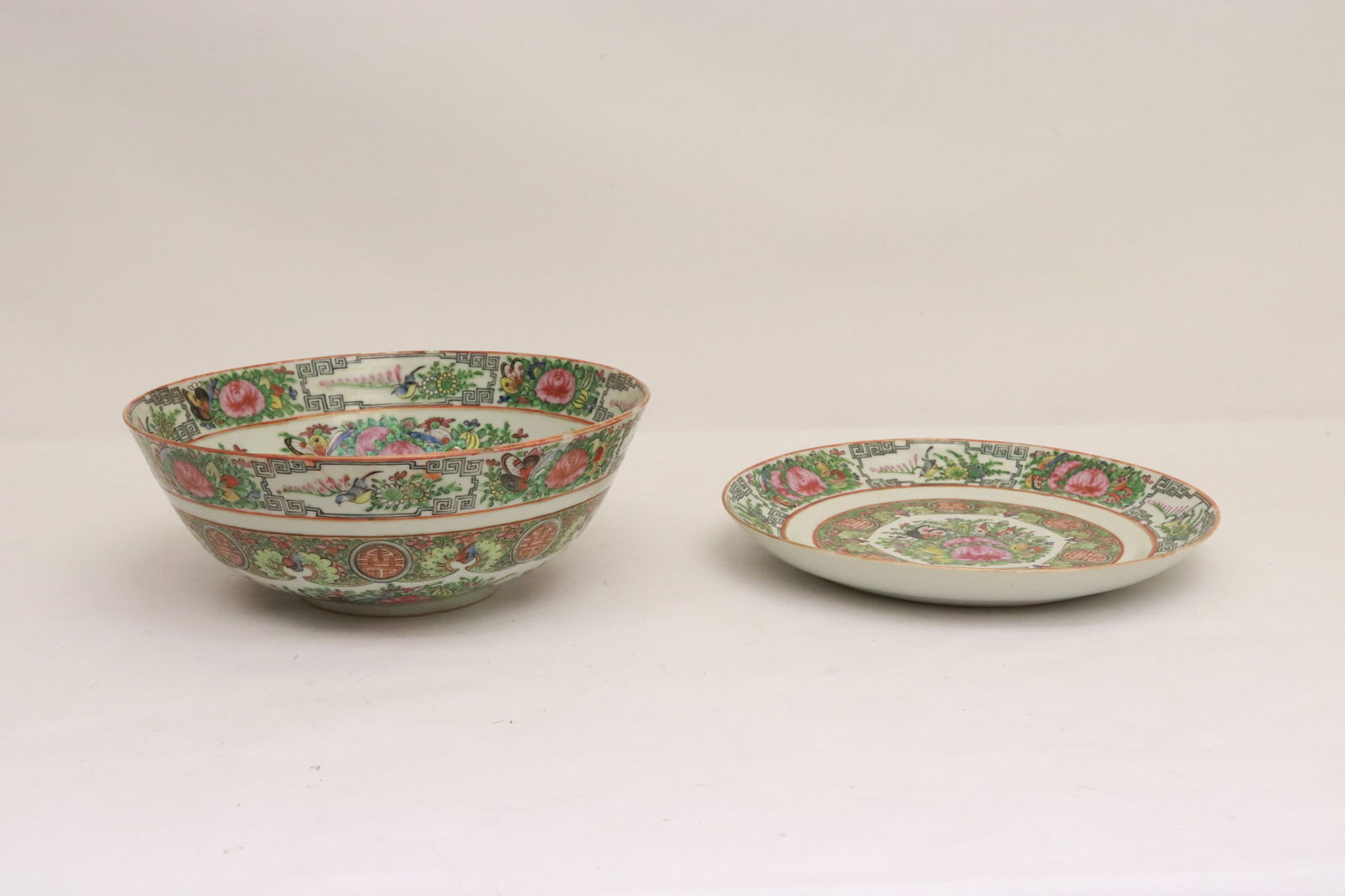 2 large rose canton pieces: 2 pieces; large 19th century rose canton bowl (flea bites on edge) (4.15"x10.6"dia), and a large rose canton round platter (1.5"x10.65"dia)