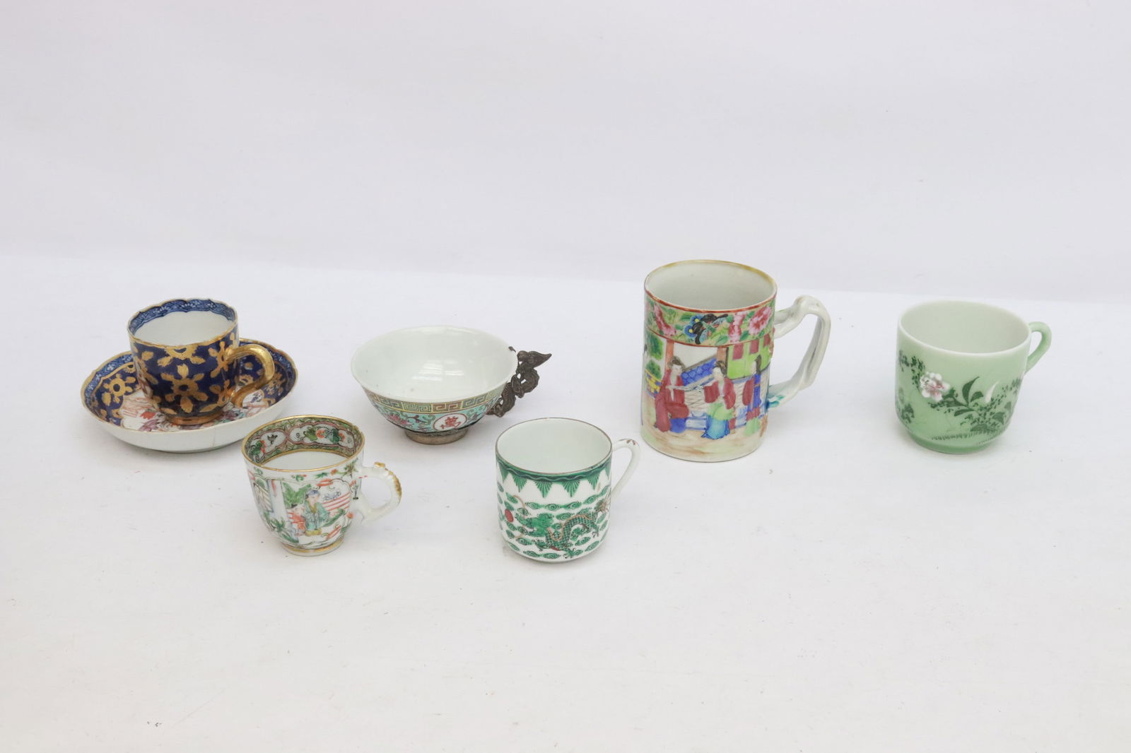 6 pieces: 6 pieces (2.25"x2.95"x2.2" - 3.65"x4.15"x2.8"); 19th century cup and saucer (saucer repair), vintage tea cup with fancy silver like mount, 19th century famille rose pitcher, and 3 vintage tea cups