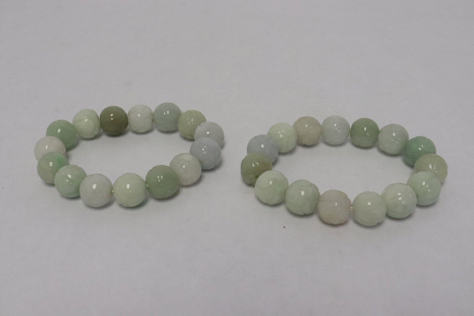 2 carved jadeite bead bracelets: 2 carved jadeite bead (~13.5mm diameter) bracelets