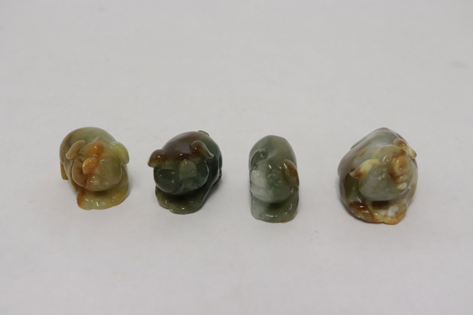4 jadeite carved animal motif ornaments: 4 jadeite carved animal motif ornaments, 0.75"x1.2"x0.63" - 0.85"x1.7"x1"