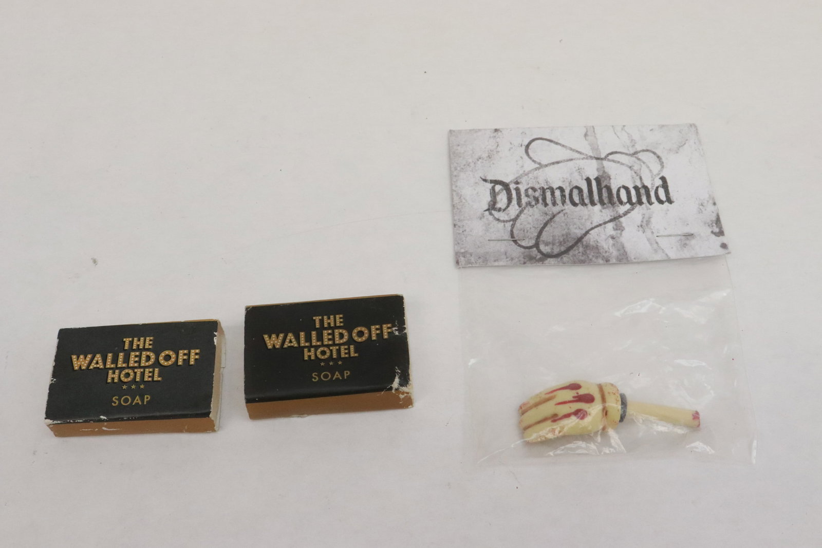 3 pieces: 3 pieces; 2 soap bars from the "Walladoff Hotel" (1.25"x2"x0.4" ea), and a "hand" ornament from Dismaland (2.18"L)