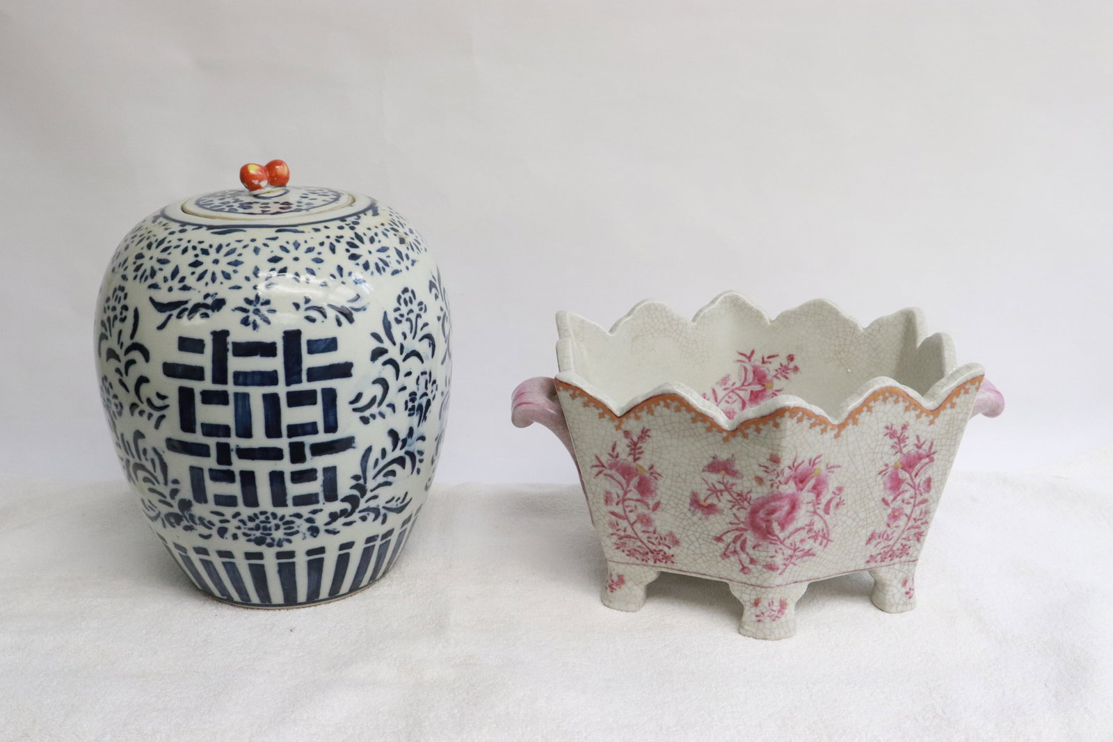 2 porcelain pieces: 2 pieces; a blue and white porcelain covered jar (9.2"x7.6"dia), and a red and white porcelain planter (5.5"x10.5"x8.15")