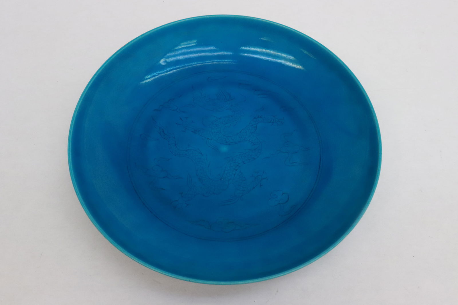 Chinese blue glazed porcelain plate: Chinese blue glazed porcelain plate incised with dragon motif decoration, 1.85"x8.8"dia