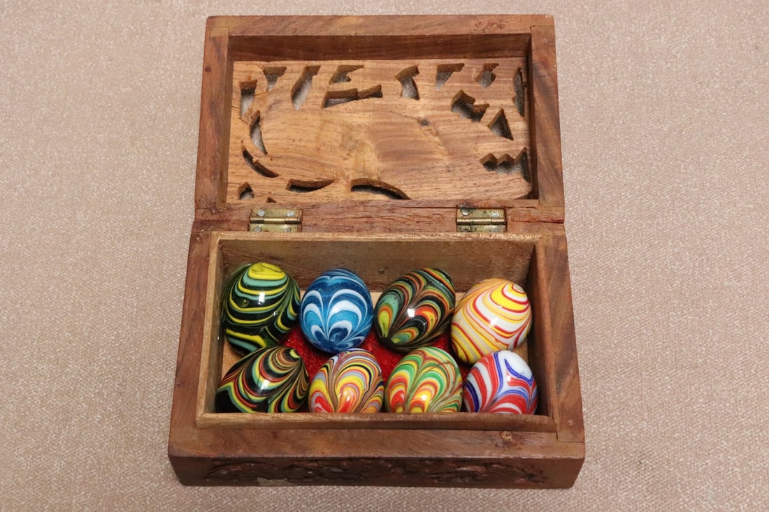 8 fancy marbles/ eggs in carved box: 8 fancy marbles/ eggs (1.4"x1.25"dia - 1.63"x1.3"dia) in carved box (2.5"x6.1"x3.95")