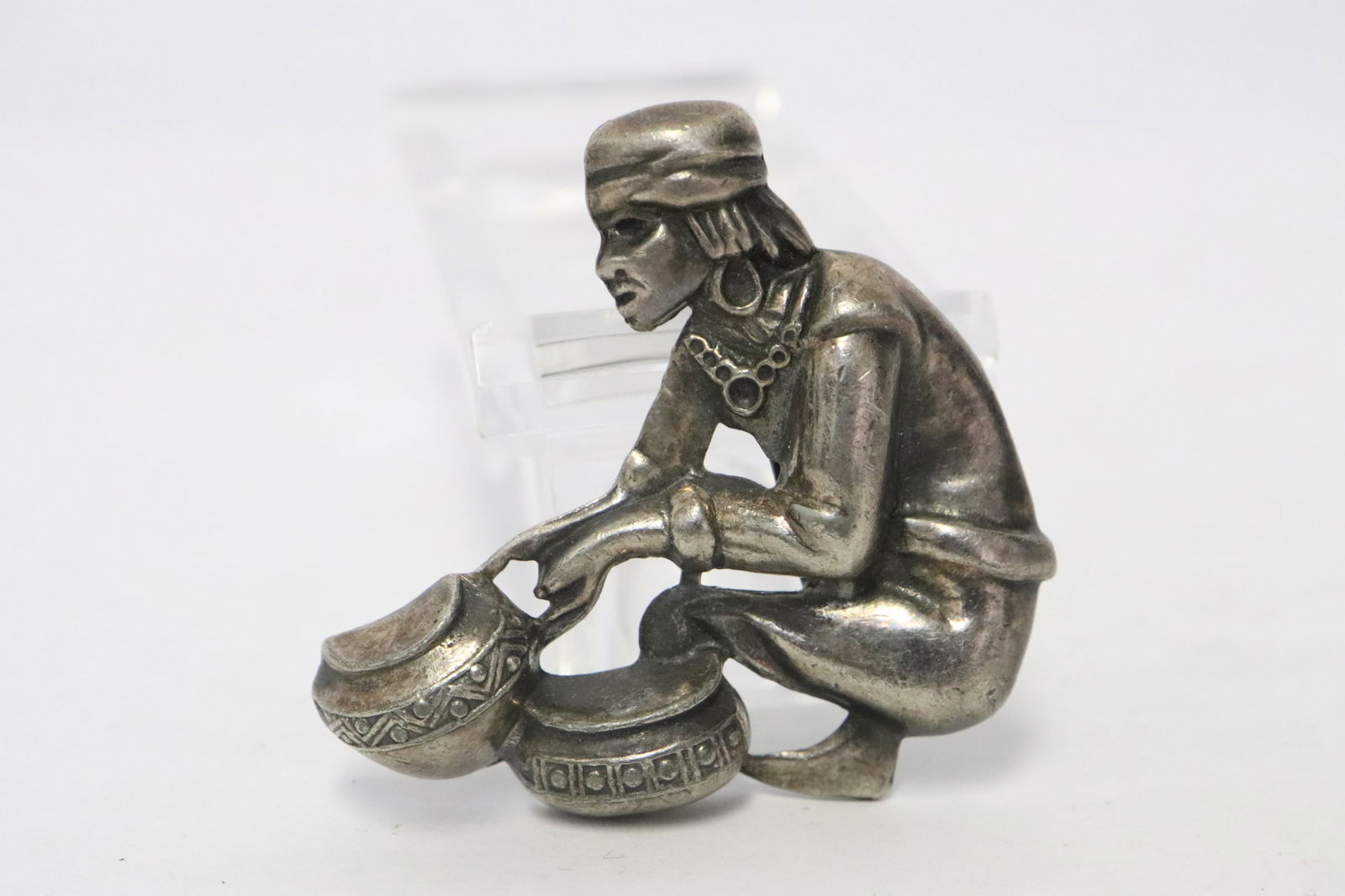 Unusual silver brooch: Unusual silver brooch depicting a Native American pot trader, the back pin is not silver, wt. 27gm