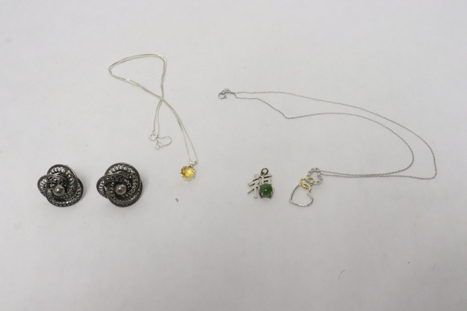 5 pieces sterling: 5 pieces sterling; 2 necklaces with pendant, pair Dancraft earrings, and a sterling pendant with jadeite stone