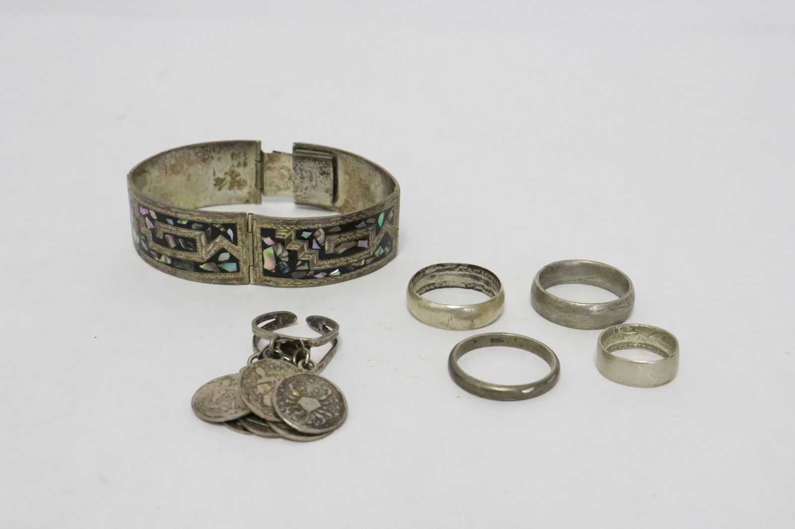 6 sterling items: 6 items; sterling bracelet with mother of pearl inlaid, sterling ring with silver coins, and 4 sterling bands, total wt. 57.2gm