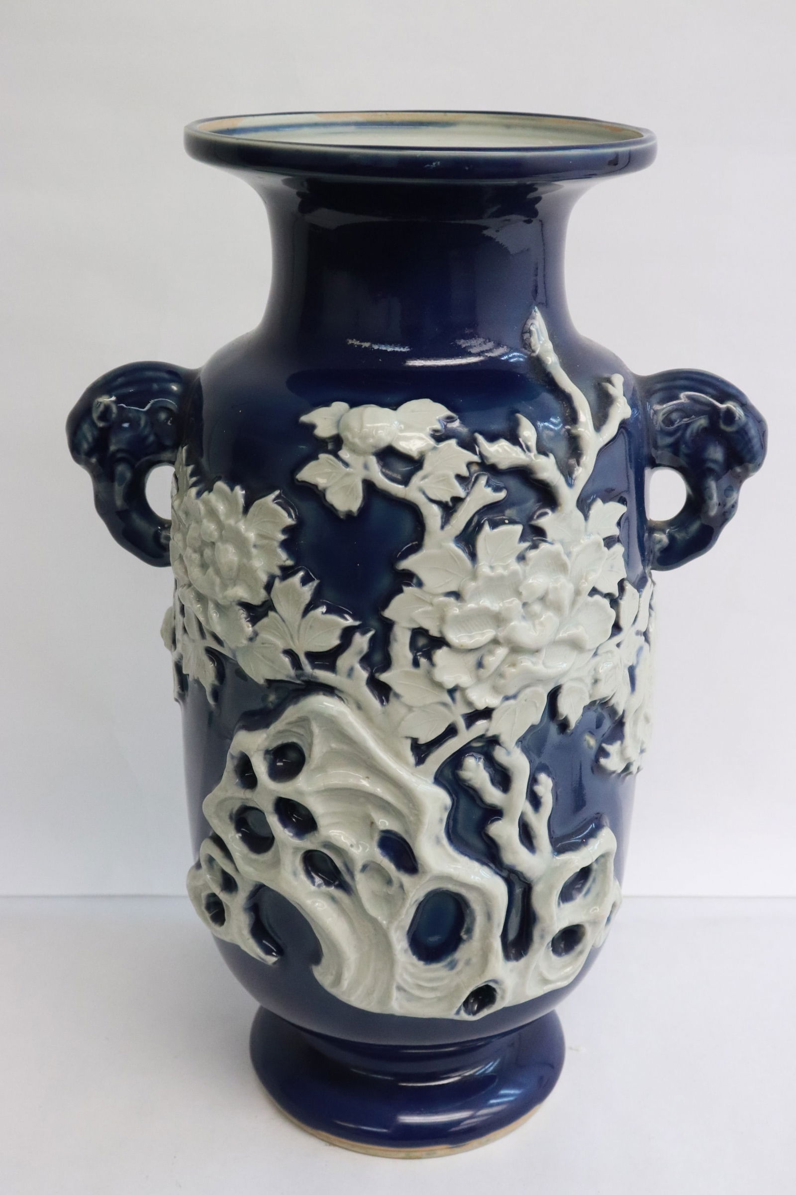 18th c. white on blue porcelain vase, Qianlong period: An important 18th century white on blue porcelain vase with decoration in relief depicting qilin and flowers, Qianlong period, 14.4"x9.4"x7.1"