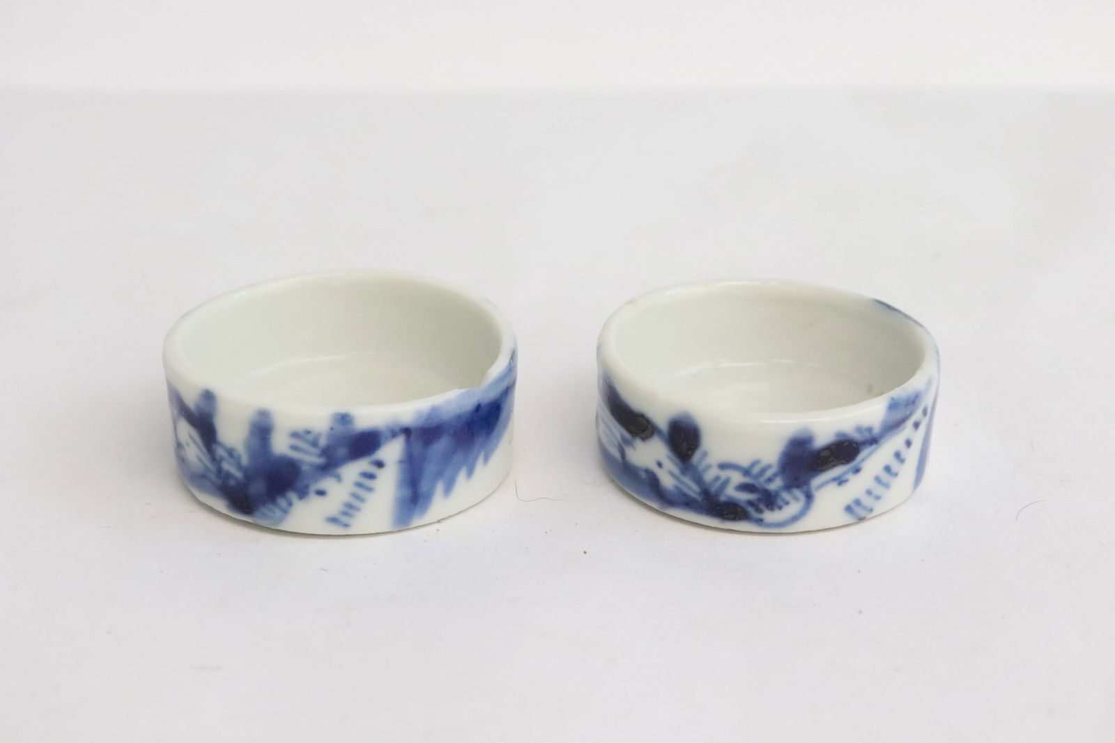 Pair late 19th c. blue & white porcelain bird feeders: Pair late 19th century blue and white porcelain bird feeders, one has chip on top edge, 0.65"x2"x1.68" ea