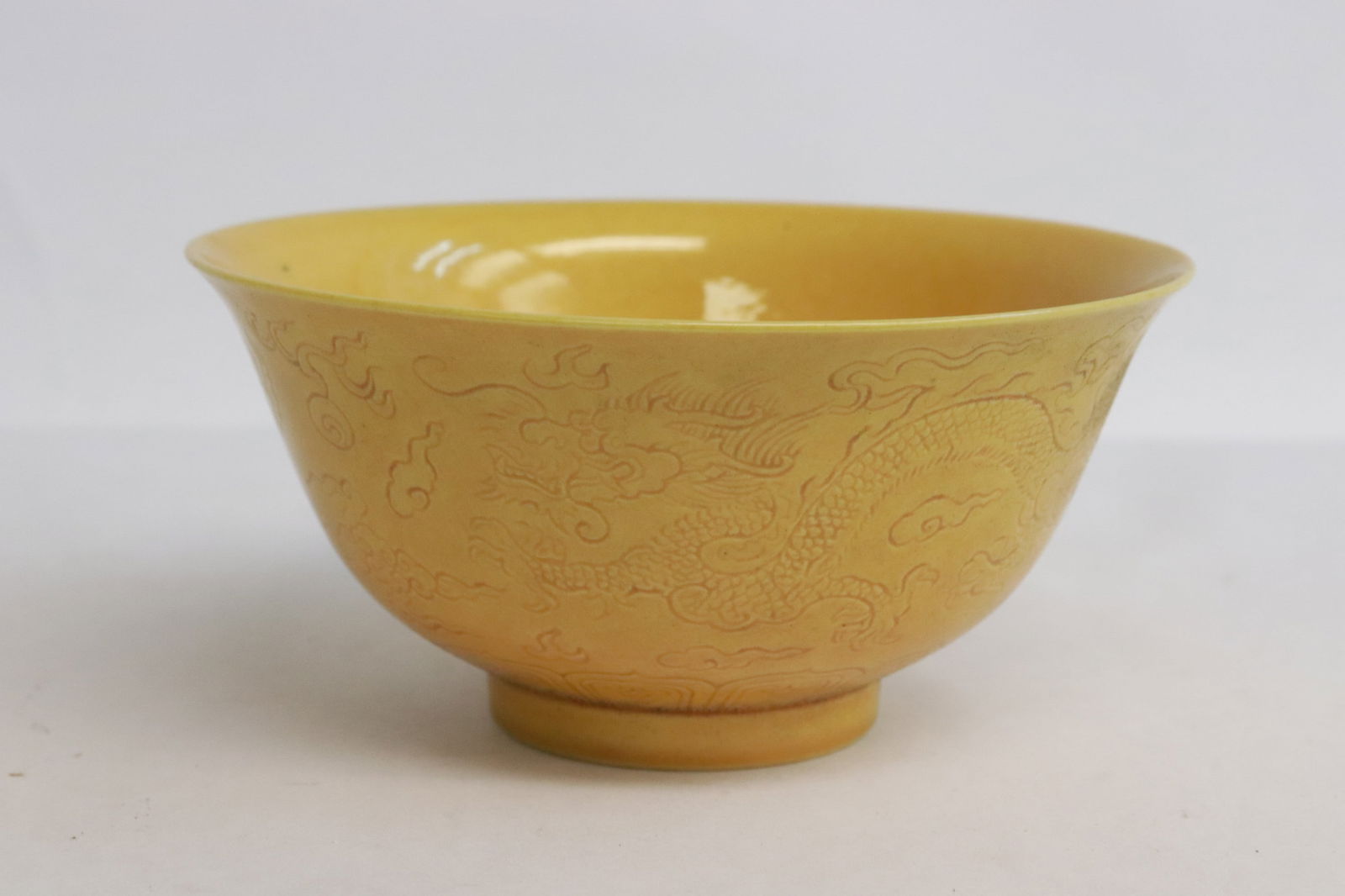 A yellow glazed porcelain bowl: A yellow glazed porcelain bowl with incised decoration, 2.2"x4.3"dia