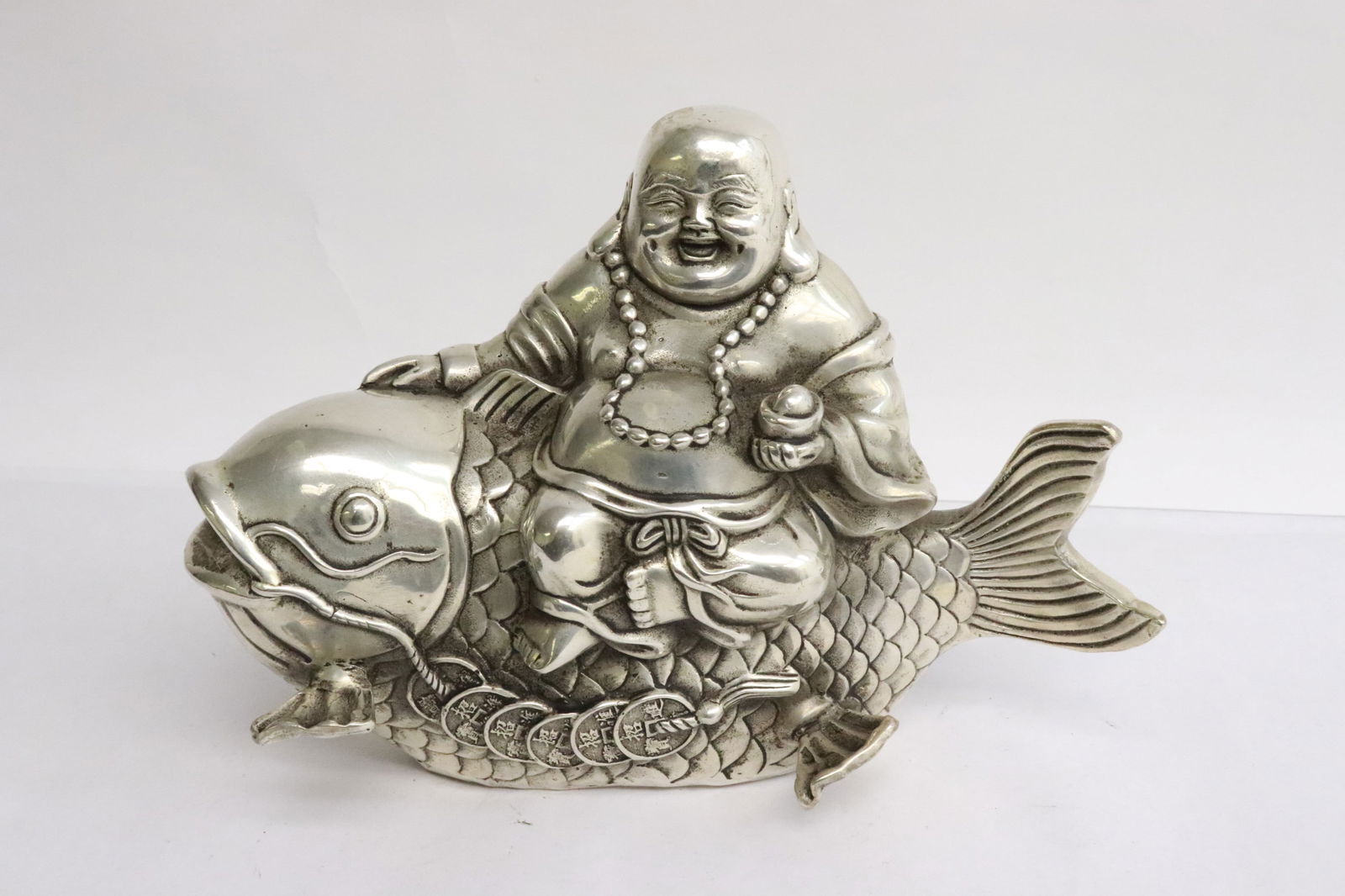 White bronze sculpture: White bronze sculpture depicting deity riding on fish, 6"H