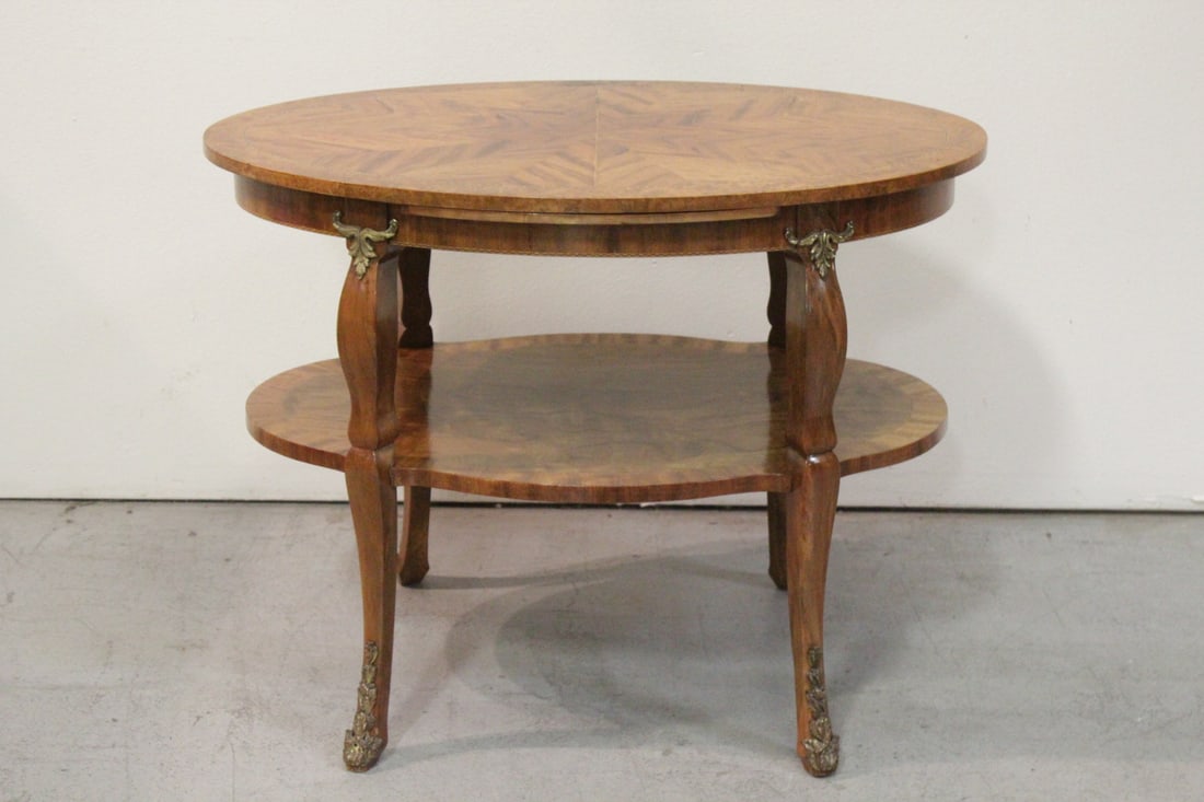 European 2-tier oval center table w/ bronze ormolu: European 2-tier oval center table with bronze ormolu, veneer minor chip, 40"x37.5"x21.5"