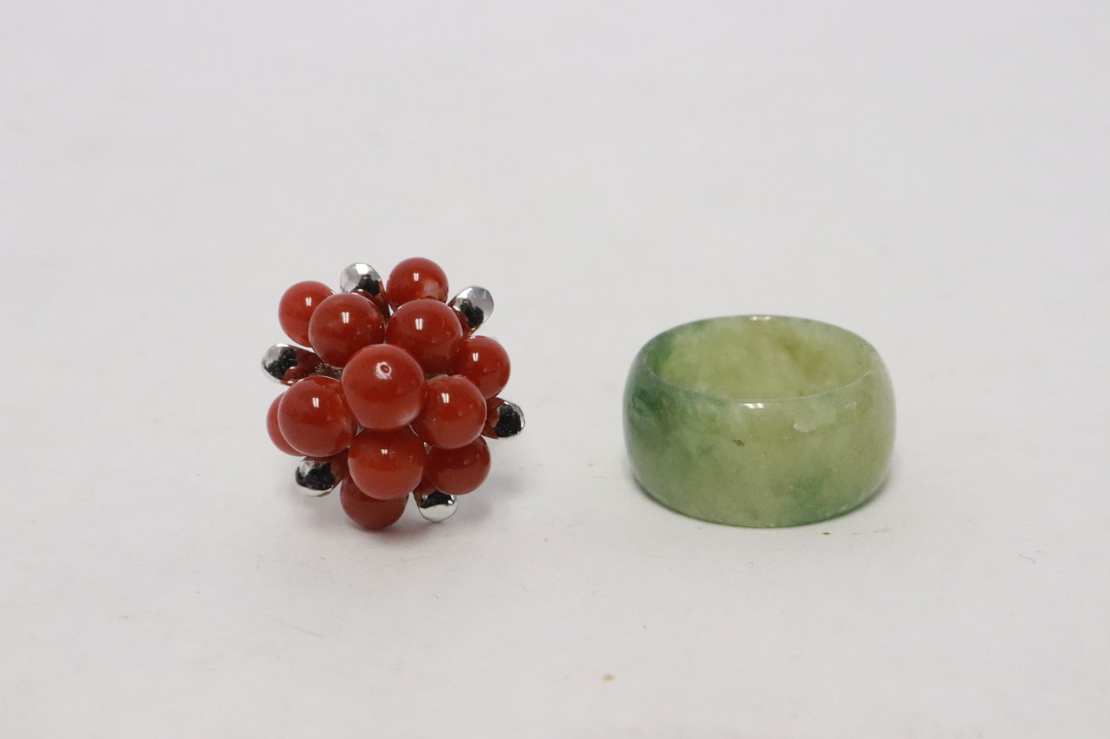 a jadeite like bangle ring, & a ring with coral: 2 pieces; a jadeite like bangle ring (0.4"x0.88"dia), and a ring with coral, NO INTERNATIONAL SHIPPING OF CORAL