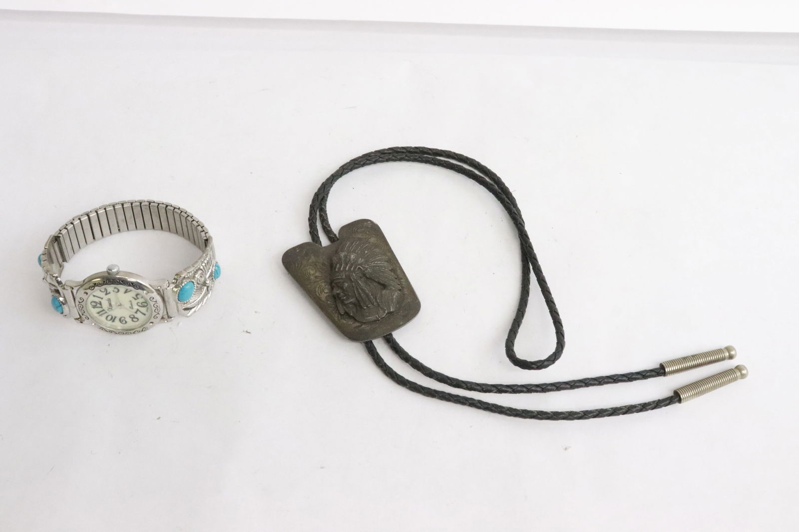 A bolo tie and a watch: A bolo tie (2.3"x1.85"x0.45" (35.4"L)), and a watch