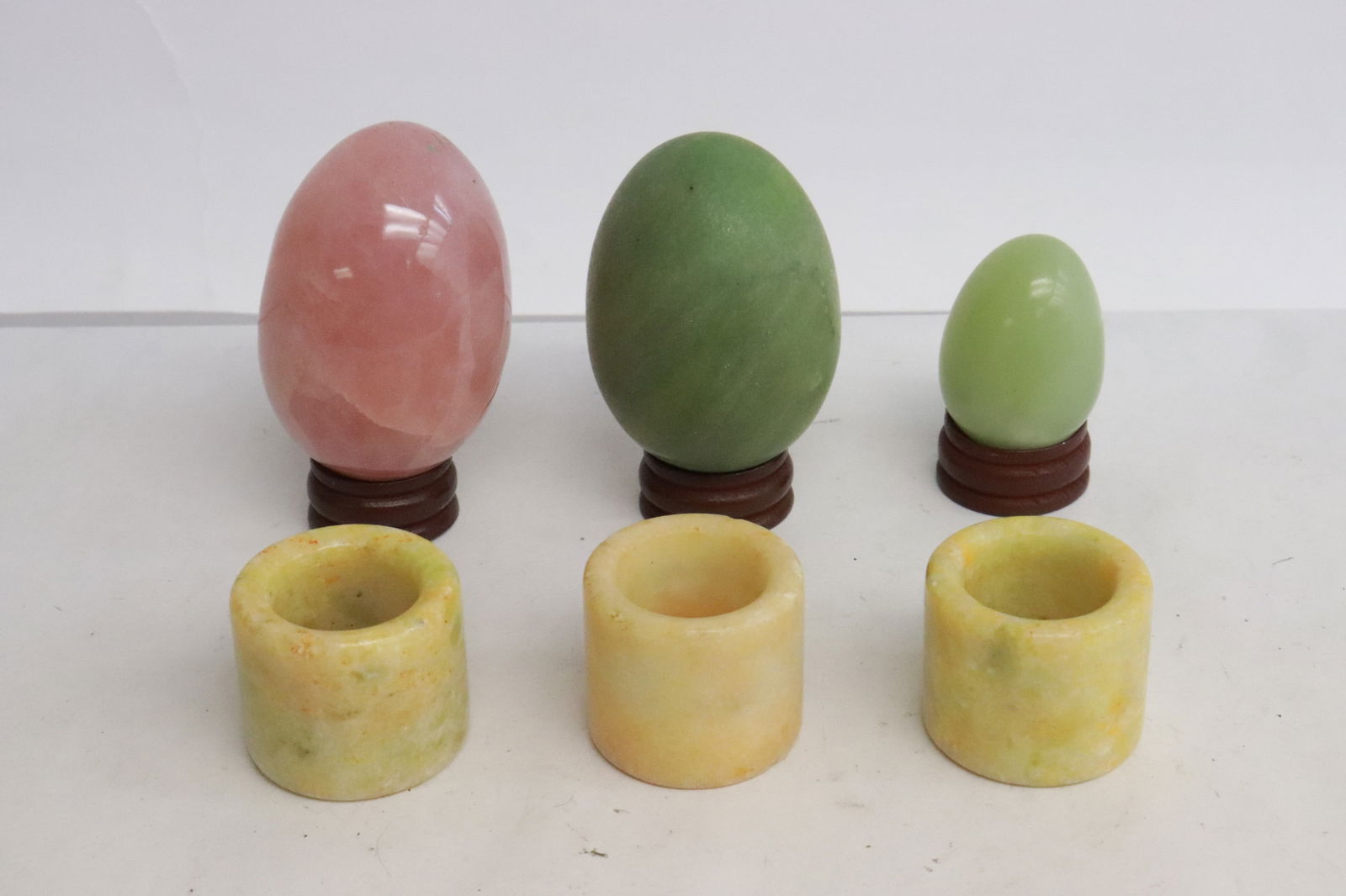 3 stone carved eggs, and 3 stone archer's rings: 6 pieces; 3 stone carved eggs (1.65"x1.25"dia - 2.6"x1.75"dia), and 3 stone archer's rings (1.15"x1.3"dia - 1.17"x1.33"dia)