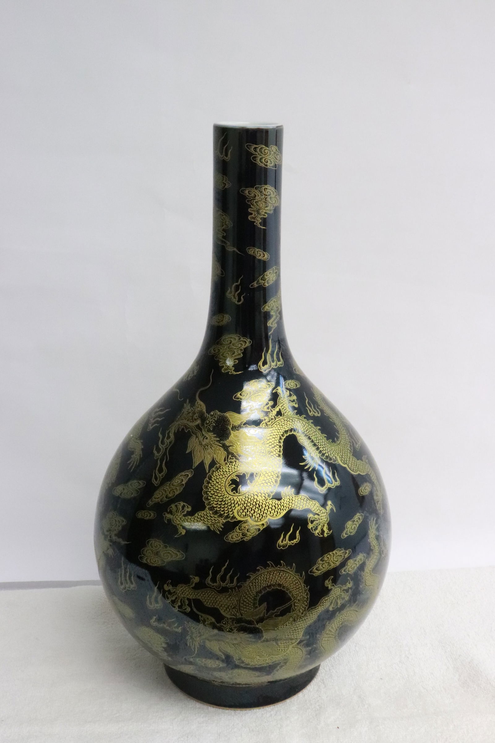 Fine Chinese gold on black porcelain bottle vase: Fine Chinese gold on black porcelain bottle vase, 16.75"x9.15"dia