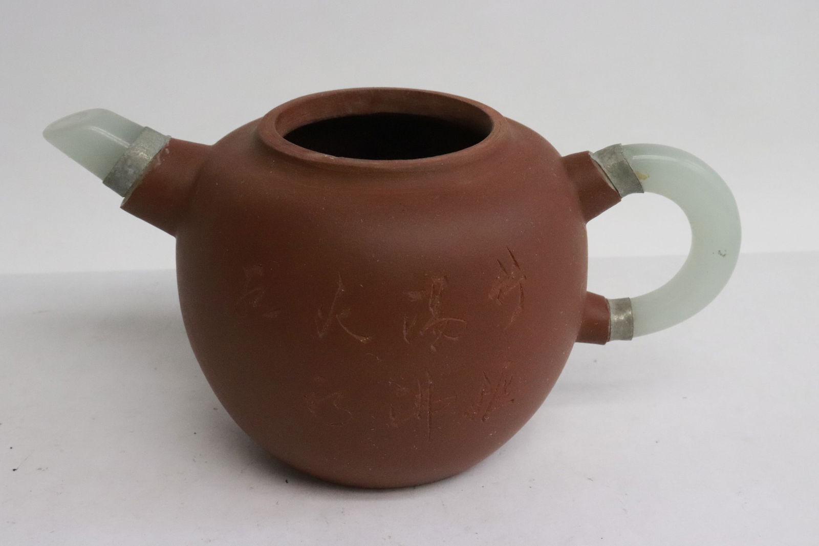 A Yixing teapot with jade like top and spout: A Yixing teapot with jade like top and spout, 3.8"x6.3"x3.8"