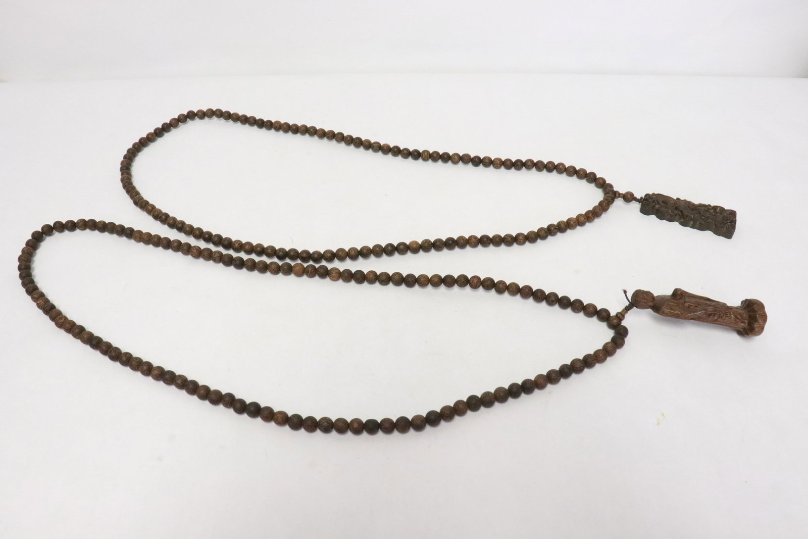 2 agarwood style bead necklace with pendant: 2 agarwood style bead (0.3"x0.3"dia ea) necklace (37.4"L ea) with pendant (2.5"x0.9"x0.35", 3.05"x1"x0.85")