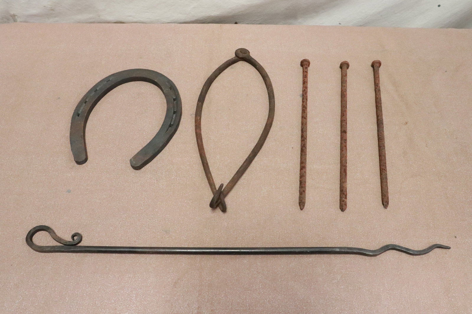 5 cast iron pieces: 5 pieces; 3 Victorian large cast iron nails (12.3"L ea), a cast iron horseshoe (8.5"x7.2"x0.4"), and 2 vintage cast iron ice picks
