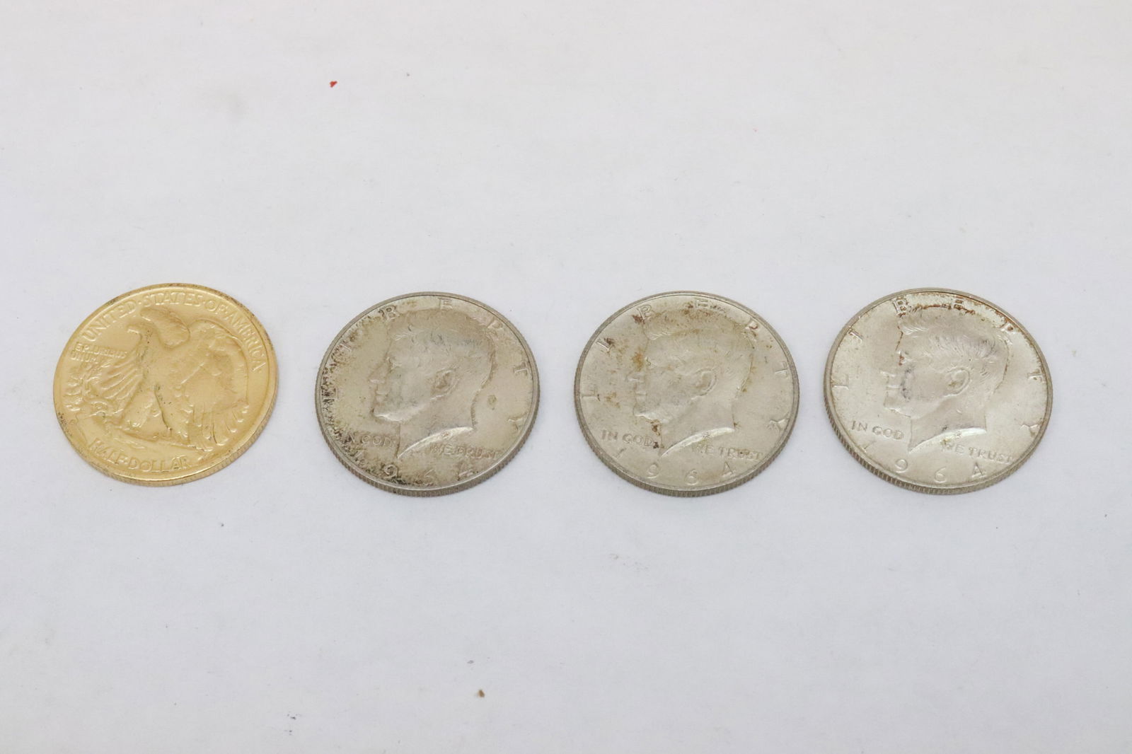 4 US silver half dollars: 4 US silver half dollars; one 1943, and three 1964