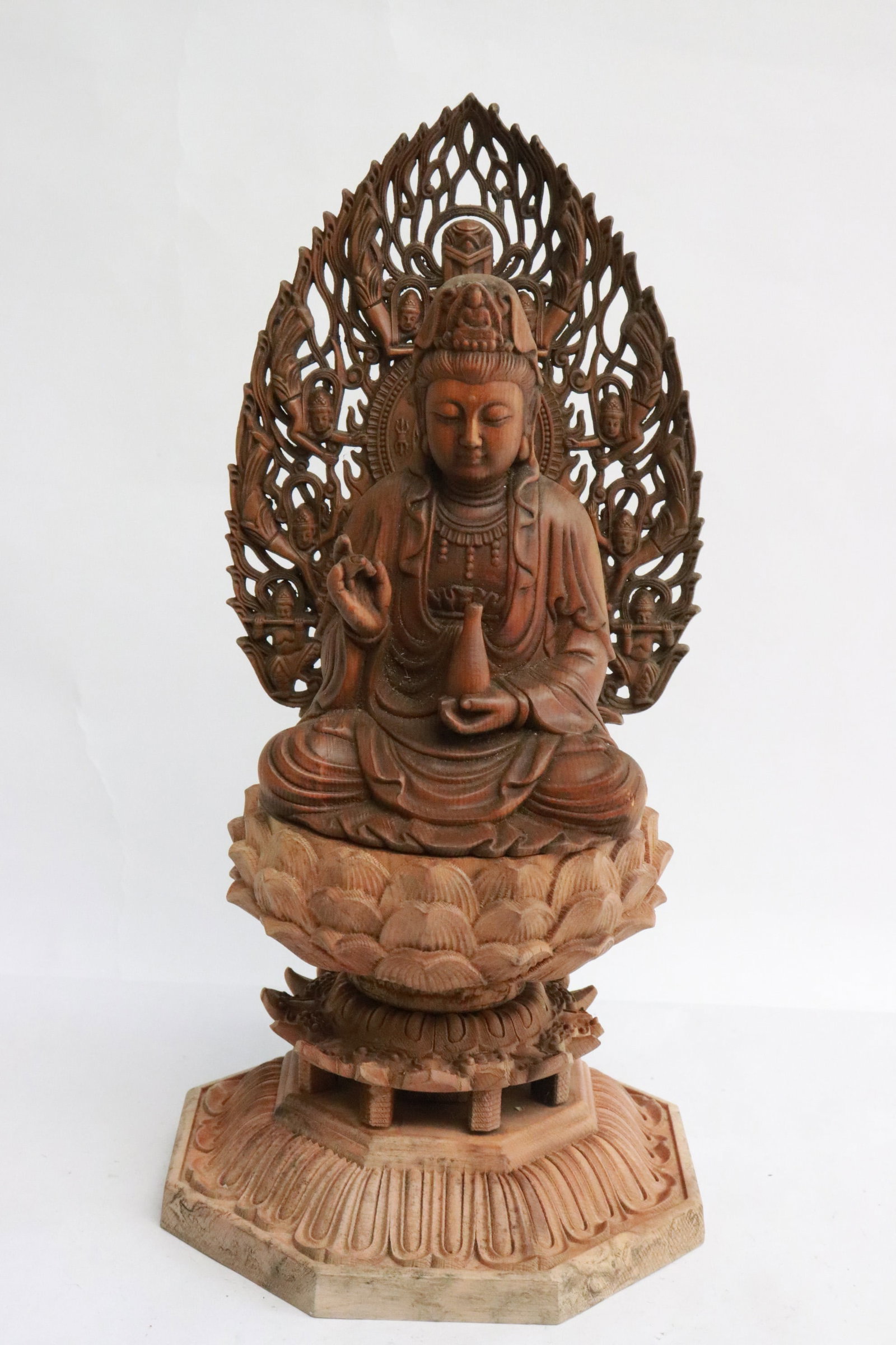 Wood carved deity on lotus flower motif stand: Wood carved deity on lotus flower motif stand, 9.85"H