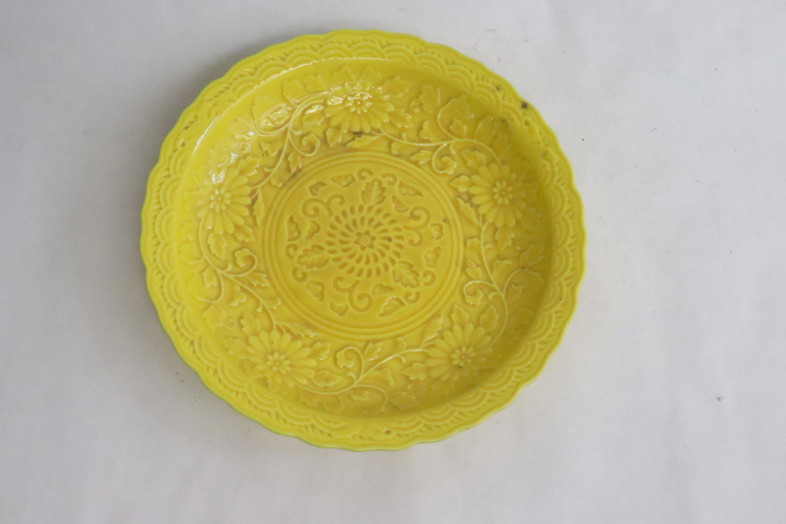 Yellow glazed porcelain plate: Yellow glazed porcelain plate with embossed decoration, 1.4"x7.3"dia