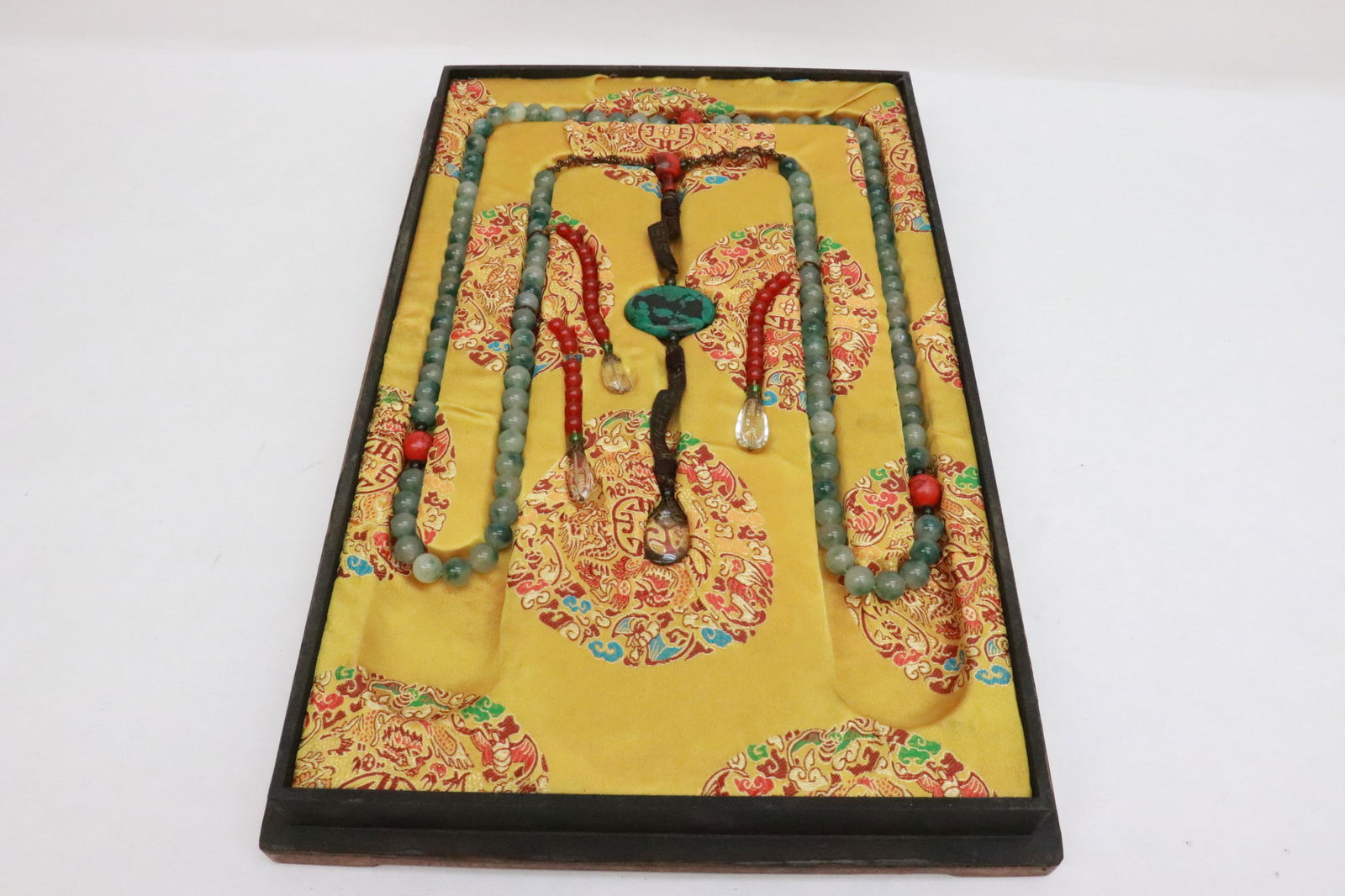 A long necklace stored in lacquer like box: A long necklace (61"L) stored in lacquer like box (2.15"x18.85"x12.2")